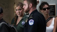 WASHINGTON, DC - OCTOBER 04:  Comedian Amy Schumer waits to be led away after being arrested during a protest against the confirmation of Supreme Court nominee Judge Brett Kavanaugh October 4, 2018 at the Hart Senate Office Building on Capitol Hill in Washington, DC. Senators had an opportunity to review a new FBI background investigation into accusations of sexual assault against Kavanaugh and Republican leaders are moving to have a vote on his confirmation this weekend. (Photo by Alex Wong/Getty Images)