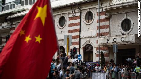 A Chinese flag is seen as Pro-Beijing protesters and members of the media gather outside the HK Foreign Correspondents&#39; Club (FCC) before Andy Chan&#39;s speech on August 14, 2018.