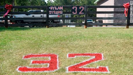 Red ribbons, the number 32 and "#DylanStrong" are seen in front of a small business Friday in Zebulon, Georgia, the home of Pike County High School.