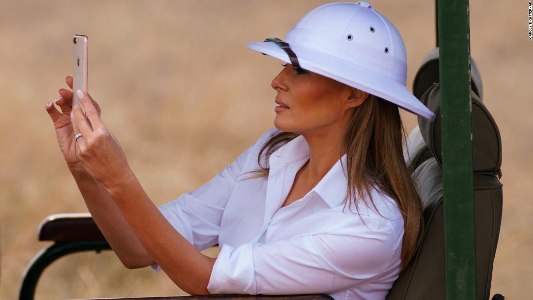 First lady Melania Trump takes photos with her cell phone during a safari at Nairobi National Park.