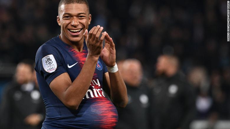 Mbappe hides the match&#39;s ball under his jersey after scoring four goals against Lyon.