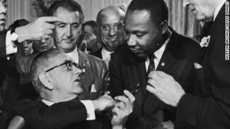  President Lyndon Johnson greets the Rev. Martin Luther King Jr. at the signing of the 1964 Civil Rights Act. 