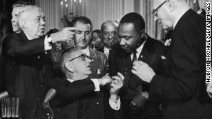 Lyndon B. Johnson and Martin Luther King shake hands