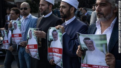 People hold posters of Saudi journalist Jamal Khashoggi during a protest organized by members of the Turkish-Arabic Media Association at the entrance to the Saudi Arabia Consulate on October 5, 2018 in Istanbul.