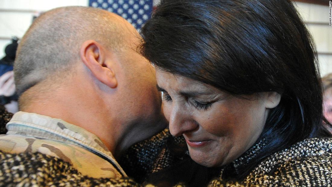 Haley hugs her husband after his Army National Guard unit returned in 2013. Michael Haley was deployed in Afghanistan for a year. He was part of an agricultural team that trained Afghan farmers how to turn their poppy crops into food crops.