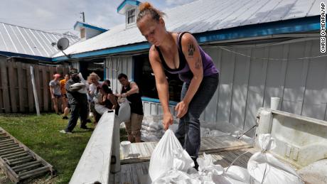 Krystal Day, of Homosassa, Fla., leads a sandbag assembly line at the Old Port Cove restaurant on Tuesday in Ozello, Fla. 