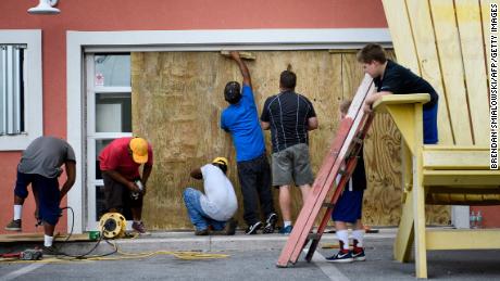 Workers boarded the windows of Marco's Pizza in Panama City Beach , Florida as Hurricane Michael approached Tuesday.  