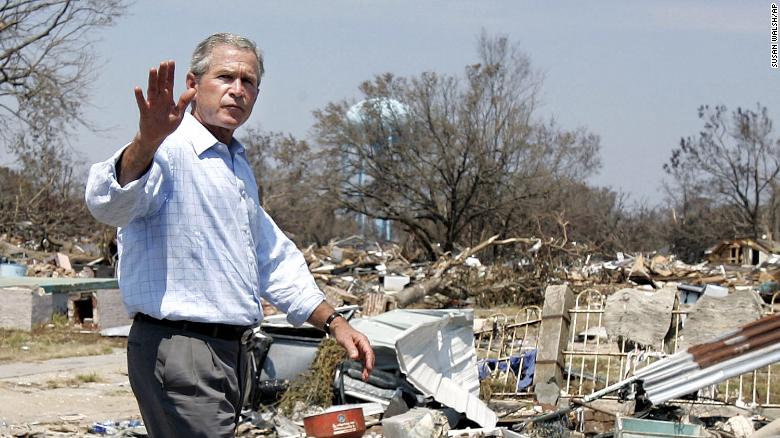 President Bush waves as he takes a walking tour of Biloxi, Mississippi, after Hurricane Katrina on September 2, 2005.