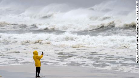 An unidentified person takes pictures Wednesday on Okaloosa Island in Fort Walton Beach.