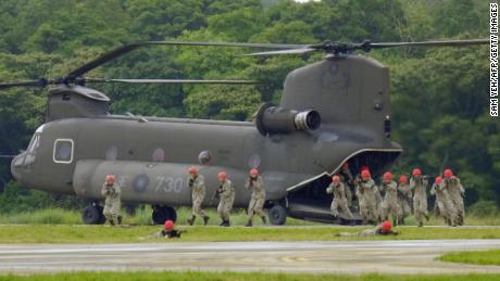 Taiwan soldiers exit from a US-made CH-47SD helicopter during military drills in Taoyuan on October 9.