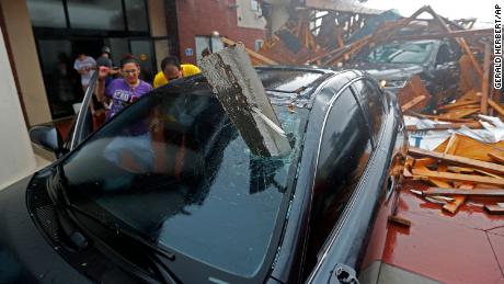 A woman checks on her vehicle after the hotel canopy collapsed in Panama City Beach.