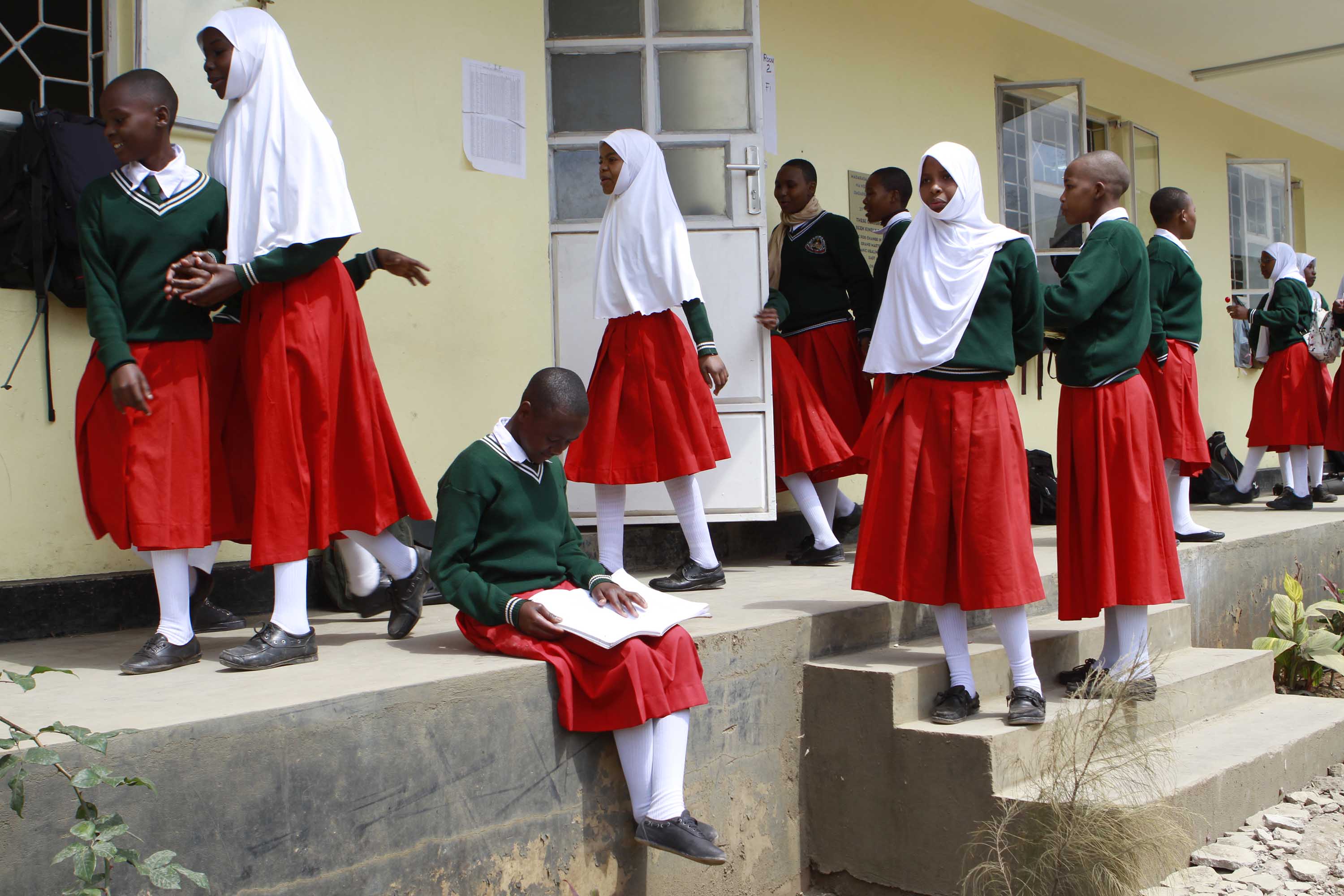Girls gather between lessons at Arusha Secondary School. At least once a semester, after coming back from holidays, the girls are rounded up in the dining hall for a mandatory pregnancy test.