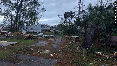 Downed trees and debris litter the mobile home park in Panama City.