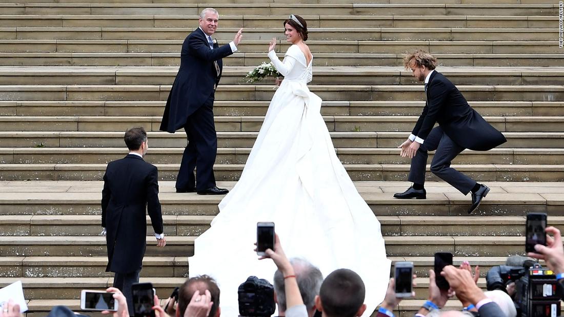 Princess Eugenie and her father Prince Andrew make their way up the steps at St. George&#39;s Chapel.