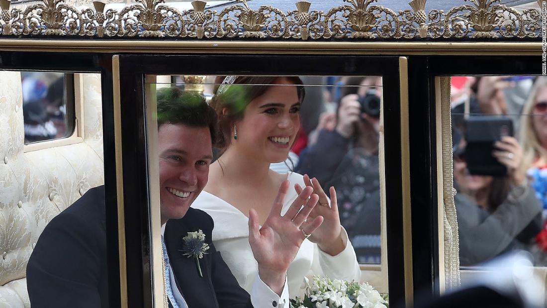 Princess Eugenie and Jack Brooksbank wave at the start of their carriage procession.