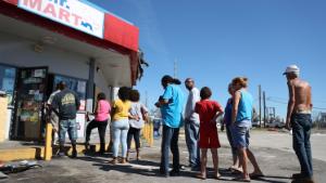 PANAMA CITY, FL - OCTOBER 12:  People line up to purchase what they can at the Mr. Mart store after Hurricane Michael passed through the area on October 12, 2018 in Panama City, Florida. The hurricane hit the Florida Panhandle as a category 4 storm causing massive damage.  (Photo by Joe Raedle/Getty Images)