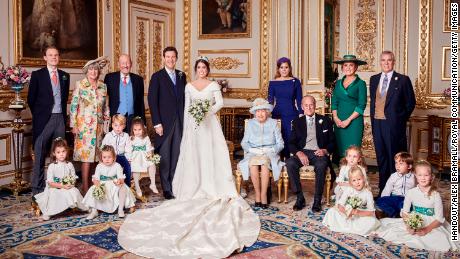 Princess Eugenie and her husband, Jack Brooksbank, stand next to Queen Elizabeth and Prince Philip following their wedding on October 12. Seated next to Brooksbank are Prince George and Princess Charlotte. Eugenie&#39;s sister, Princess Beatrice, and parents, Sarah, Duchess of York, and Prince Andrew, appear on the right.