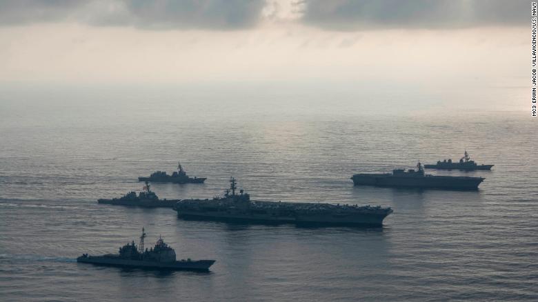 The aircraft carrier USS Ronald Reagan, second from bottom,  the guided-missile cruiser USS Antietam, bottom, and the guided-missile destroyer USS Milius, left, conduct a photo exercise with the Japan Maritime Self-Defense Force helicopter destroyer JS Kaga , second from top, and the JMSDF destroyers JS Inazuma and JS Suzutsuki . 