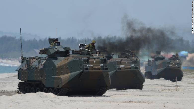 Japanese Ground Self Defense Forces' amphibious assault vehicles hit the beach during an amphibious landing exercise in the Philippines in 2018.
