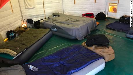 The interior of a sleeping tent for firefighters at their base camp in a Panama City mall.