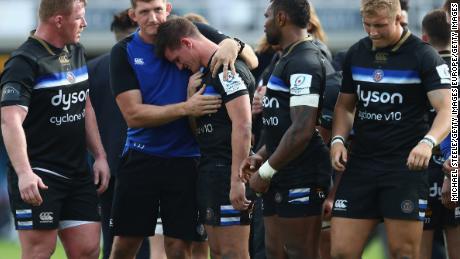 Freddie Burns is consoled by Stuart Hooper at the final whistle. 