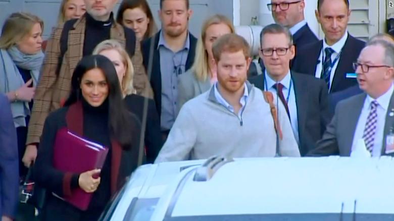 Britain's Prince Harry, center right, and his wife Meghan, left, arrived in Sydney on Monday. 