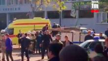 In this image made from video, showing the scene as emergency services load an injured person onto a truck, in Kerch, Crimea, Wednesday Oct. 17, 2018.  An explosive device has killed several people and injured at least 50 others at a vocational college in Crimea Wednesday in what Russian officials have called a possible terrorist attack. (Kerch FM News via AP) KERCH.FM LOGO CANNOT BE OBSCURED