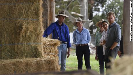 Prince Harry and wife Meghan chat with farmers Scott Woodley, his daughter Laura and wife Elaine during a visit to their drought-affected farm in Dubbo.