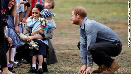 Meghan, Duchess of Sussex, gets a hug and a bouquet of flowers from 5-year-old Luke Vincent.