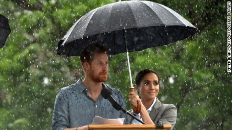 Prince Harry speaks as a rare, welcome outbreak of rain falls in Dubbo, in rural New South Wales.