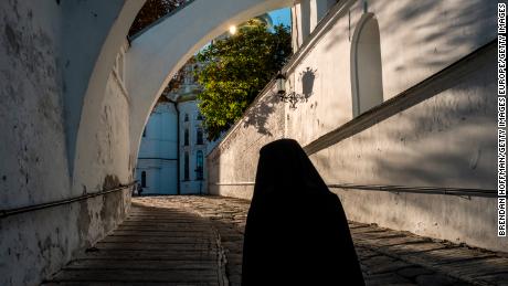 A monk walks to the Evening Divine Office service at the Refectory Church of Sts. Anthony and Theodosius at the Kyiv-Pechersk Lavra in Kiev, Ukraine.