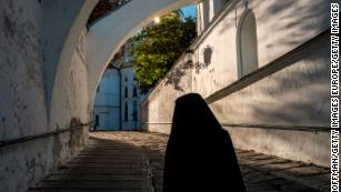 A monk walks to the Evening Divine Office service at the Refectory Church of Sts. Anthony and Theodosius at the Kyiv-Pechersk Lavra in Kiev, Ukraine.