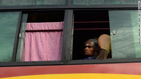 A Hindu devotee looks out from a shuttle bus going to the temple.