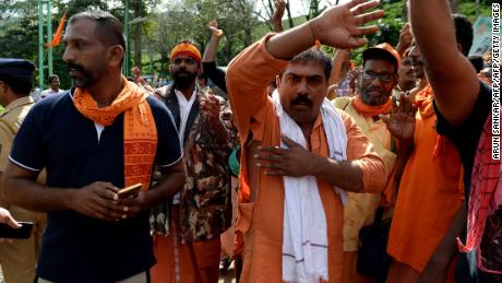 A devotee displays his torn shirt during scuffles with police in the protest.