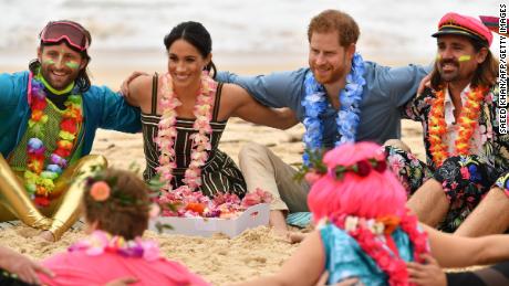 The duke and duchess join a circle during a "Fluro Friday" session run by OneWave at Sydney's iconic Bondi Beach on October 19.