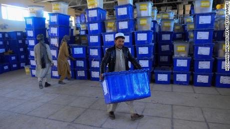 Afghan employees of the Independent Election Commission carry ballot boxes at a warehouse in Herat province on Wednesday.