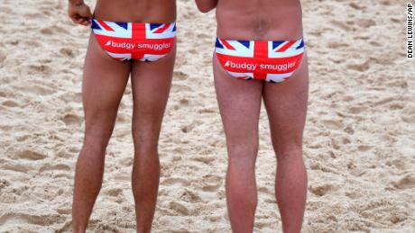 Two men wearing Union Jack 'Budgy Smugglers' as they wait for Britain's Prince Harry at Bondi Beach on October 19.