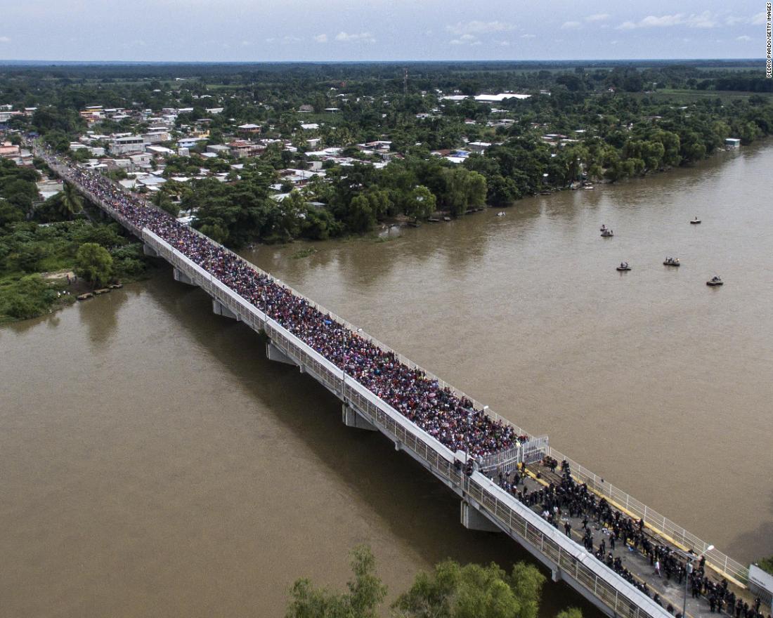 An aerial view shows a Honduran migrant caravan heading to the United States as it is stopped at a border barrier on the Guatemala-Mexico international bridge in Ciudad Hidalgo, Mexico, on Friday, October 19. 