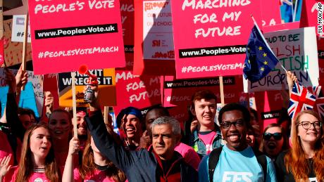 London Mayor Sadiq Khan, front center, holds a klaxon horn as he joins protesters in the People&#39;s Vote March for the Future on Saturday.