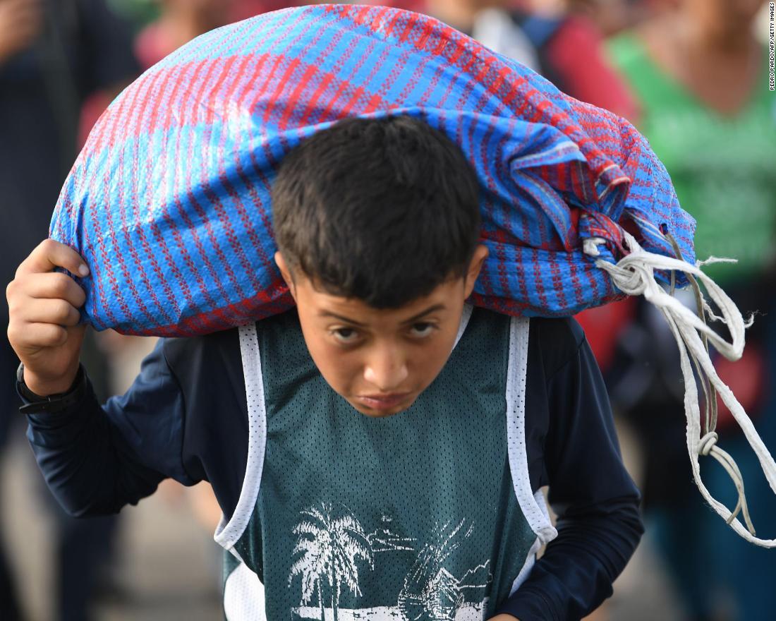 A Honduran migrant boy, part of a caravan heading to the United States, walks on the road linking Ciudad Hidalgo and Tapachula, Chiapas state, Mexico, on Sunday.