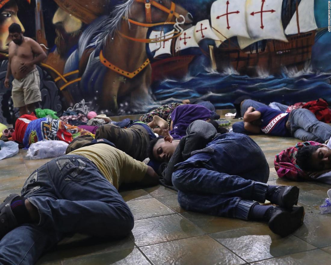 Migrants still on the Guatemalan side of the border sleep at a temporary immigrant shelter on Sunday in Ciudad Tecun Uman, Guatemala. The caravan of thousands of Central Americans made its way into Mexico with some members hoping to eventually reach the United States.