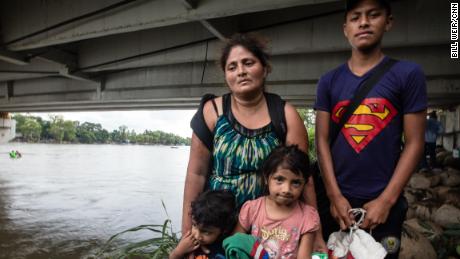 The Guillermo family pose for a photo, moments after reaching Mexico. Rosalin stands with her son Miner, 16, three-year-old Carlitos and Candy, 5.