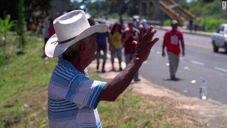 Miguel Hernandez waved as he watched the migrant caravan pass by in the southern Mexican state of Chiapas.