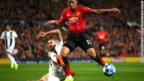 Anthony Martial is tackled by Leonardo Bonucci.