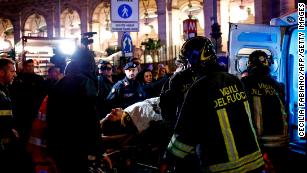 First responders evacuate a wounded person from Piazza della Repubblica in central Rome.