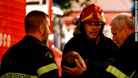 First responders tend to a wounded person on Piazza della Repubblica in central Rome.