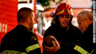 First responders tend to a wounded person on Piazza della Repubblica in central Rome.