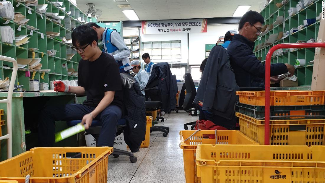 Workers for Korea Post sort packages and letters. The company has faced repeated pressure from workers and the government to reduce employee hours on the job. 