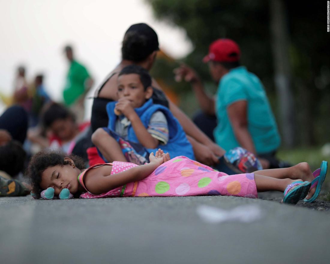 Families rest on a roadside between Mapastepec and Huixtla, Mexico, while traveling with thousands of migrants from Central America in a caravan en route to the United States, on Wednesday, October 24.