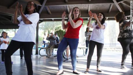 Katie Hill, center in red, dances at a campaign Halloween carnival event in Lancaster, California. 